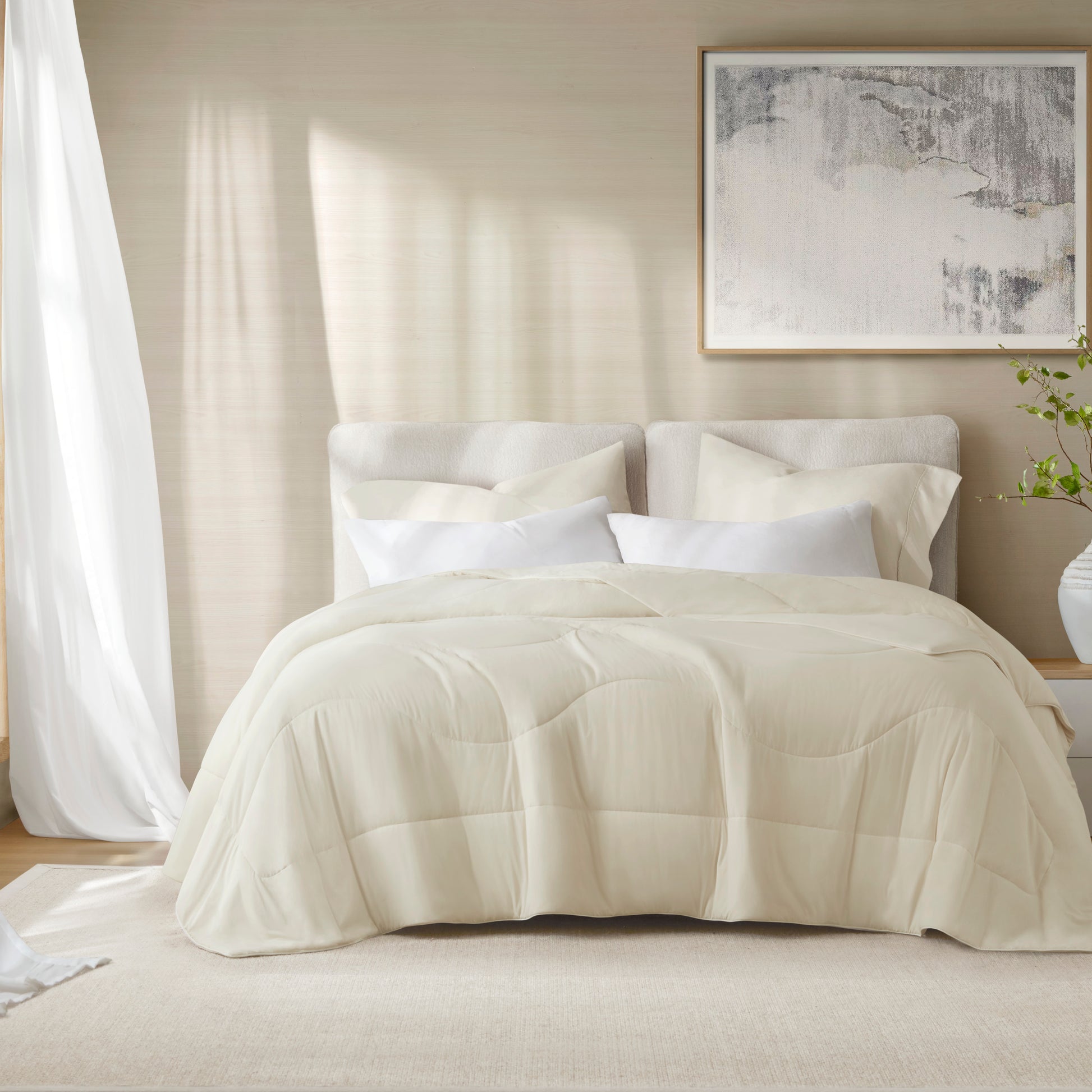 Eco-friendly cream-colored bedding set with soft, quilted texture on a neatly made bed, complemented by white pillows and a light, airy ambiance.